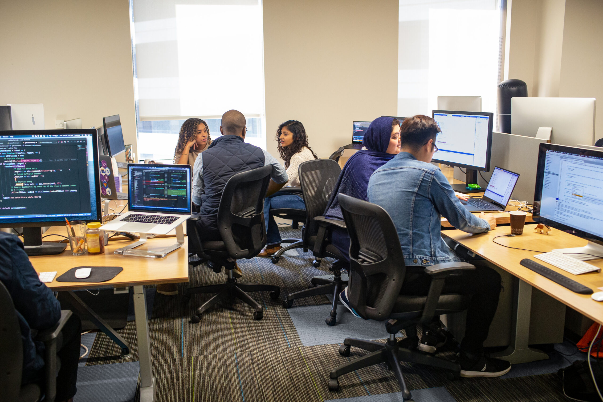 A group of people working together in an office. 